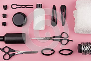 Professional hair dresser tools with copy space. Hair stylist equipment set on pink background.