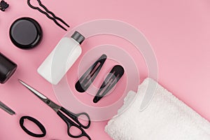 Professional hair dresser tools with copy space. Hair stylist equipment set on pink background.