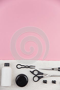 Professional hair dresser tools with copy space. Hair stylist equipment set on pink background.