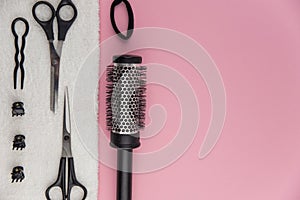 Professional hair dresser tools with copy space. Hair stylist equipment set on pink background.