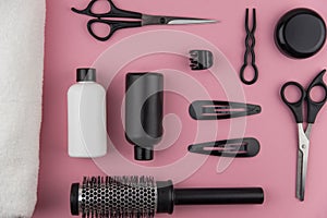 Professional hair dresser tools with copy space. Hair stylist equipment set on pink background.