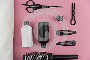 Professional hair dresser tools with copy space. Hair stylist equipment set on pink background.