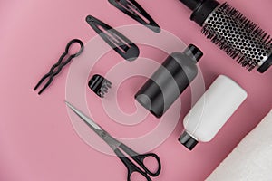 Professional hair dresser tools with copy space. Hair stylist equipment set on pink background.