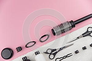 Professional hair dresser tools with copy space. Hair stylist equipment set on pink background.