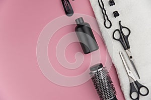 Professional hair dresser tools with copy space. Hair stylist equipment set on pink background.