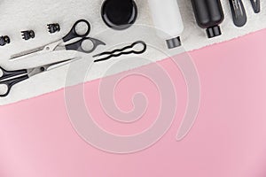 Professional hair dresser tools with copy space. Hair stylist equipment set on pink background.