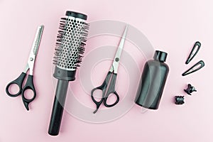 Professional hair dresser tools with copy space on trendy pink background. Hair stylist equipment set.