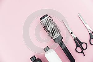 Professional hair dresser tools with copy space on trendy pink background. Hair stylist equipment set.
