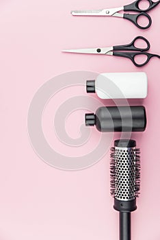 Professional hair dresser tools with copy space on trendy pink background. Hair stylist equipment set.