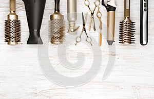 Professional hair dresser tools on wooden background with copy space