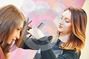 Professional hair stylist with scissors and comb