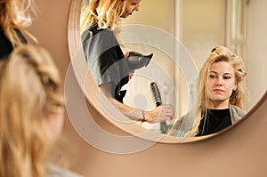 Professional hair stylist at work - hairdresser doing hairstyle