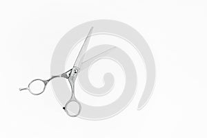 Professional Haircutting Scissors levitation. Hairdresser scissors on white background with copy space for text