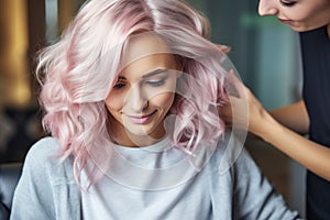 Professional hairdresser assisting girl with pink hair in hairstyling, with empty space for text