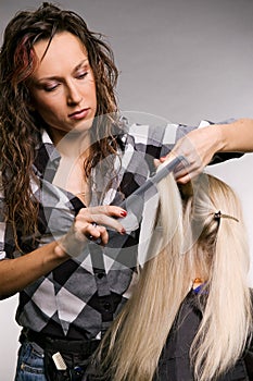 Professional hairdresser doing haircut