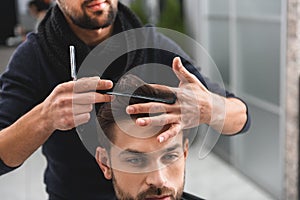 Professional hairdresser doing haircut for man