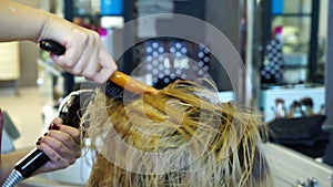 Professional hairdresser dries hair girls hair dryer