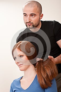 Professional hairdresser with long hair customer