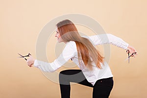 Professional hairdresser with scissors ready to cut.