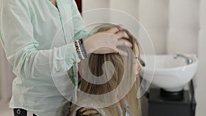 Professional hairdresser styling fixes model hair. Making volume hairstyle