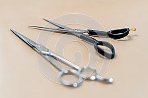 Professional hairdresser tools on brown background. Classic barber equipment - scissors