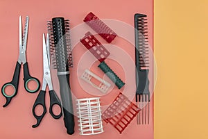 Professional hairdresser tools with copy space on colored background. Hairdresser equipment set. Scissors, comb, flat top view