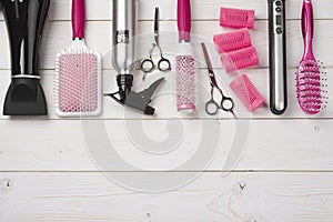Professional hairdresser tools on wooden planks background with copy space