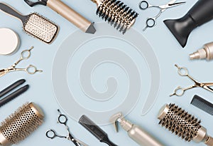 Professional hairdressing tools and accessories on blue background with space