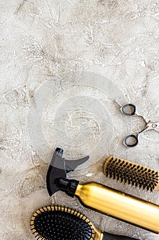 Professional hairdressing tools and accessories on stone table background top view copyspace