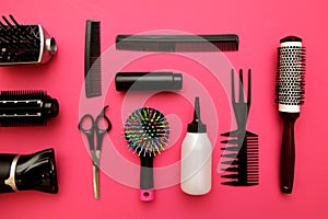 Professional hairdressing tools on pink background
