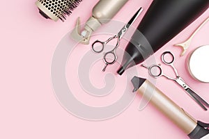 Professional hairdressing tools on pink background with copy space