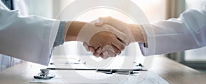 The professional handshake between two doctors in a medical consultation setting. AI generated image