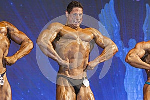 Professional Handsome Male Caucasian Bodybuilder Performing on S