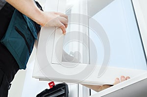 Professional handyman installing window