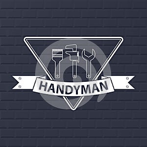 Professional Handyman. Logo of Professional Handyman on dark blue brick wall.