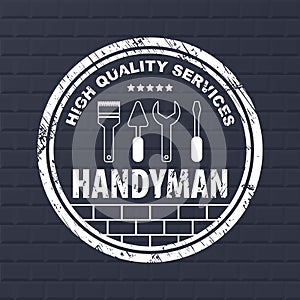 Professional handyman services logo. Stamp handyman services on dark bricks background. Stamp with dry rough edges