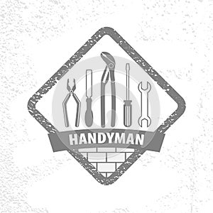 Professional handyman services logo on texture background.  Emblem with set of Repair tools for your desig. photo