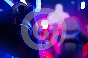 Professional headphones with microphone for video games and cyber sports on background of gaming monitor