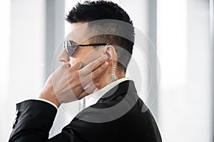 professional headshots, bodyguard communicating through earpiece