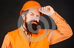 Professional Heavy Industry Engineer. Construction worker in hard hat. Bearded man in Safety Uniform and helmet. Male builder.