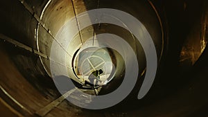 Professional Heavy Industry Worker Wearing Helmet Welding Inside Oil and Gas Pipe. Construction of