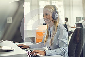 Professional helpline call center agent operator woman wearing headset working in customer care support centre.