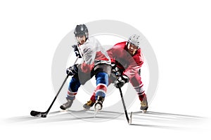 Professional hockey player skating on ice. Isolated in white