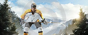 Professional hockey player. Sports emotions. Isolated on ice. Hockey player on an outdoor skating rink in the forest