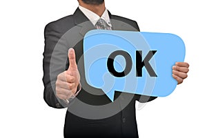 Professional holding Ok Speech Bubble in Hand with thumbs up impression