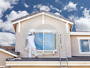 Professional House Painter Painting the Trim And Shutters of A H photo