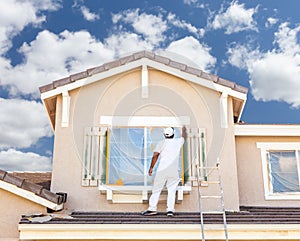 Professional House Painter Painting the Trim And Shutters of A H photo