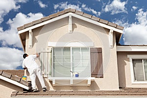 Professional House Painter Painting the Trim And Shutters of A H photo