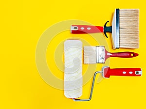 Professional house painter, work tools on yellow background