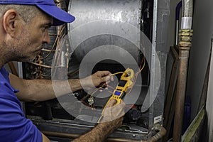 Professional Hvac Technician Checking Current on Motor Wire